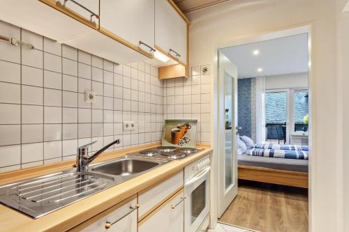 a kitchen with a sink and a bedroom at Haus Schönblick in Willingen