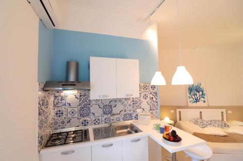 a kitchen with a sink and a stove top oven at Casa Vacanze Maya a Otranto in Otranto