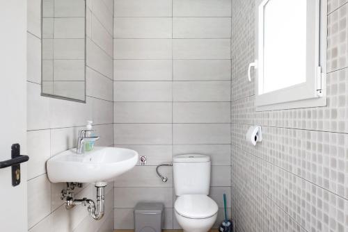 a small bathroom with a toilet and a sink at Casa Torre De Meca 2 Shared Pool in Los Caños de Meca