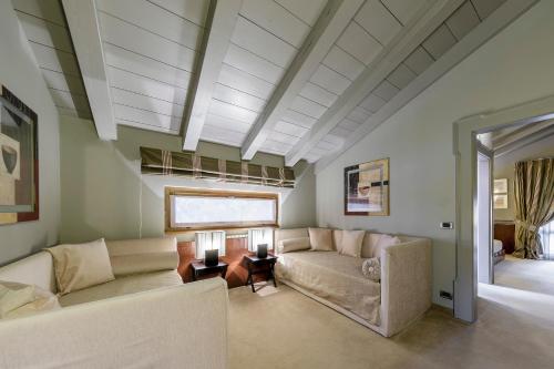 a living room with a couch and a table at Hotel Lajadira & Spa in Cortina dʼAmpezzo