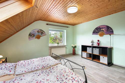 a bedroom with a bed and a wooden ceiling at Ferienwohnung Kudensee in Kudensee