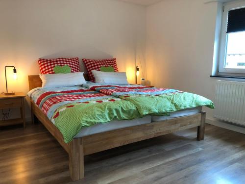 a bed in a room with two lamps and a window at Waldmomente in Schauren