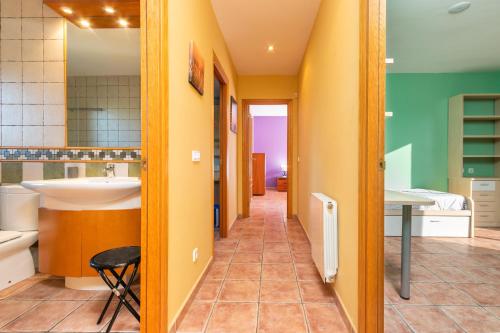 a hallway of a bathroom with a sink and a tub at Casa con piscina in Calonge