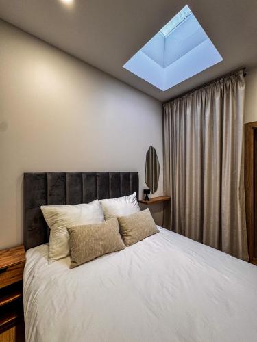 a bedroom with a large bed with a skylight at Amber loft 12 Rusnė in Rusnė