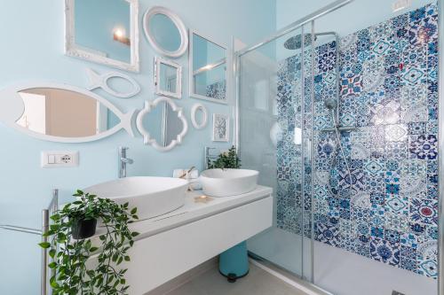 a bathroom with a sink and a glass shower at La casa dei naviganti in Villasimius