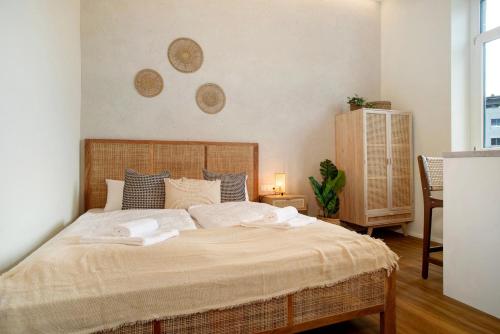 a bedroom with a large bed with towels on it at Sonnenblick Bregenz in Bregenz