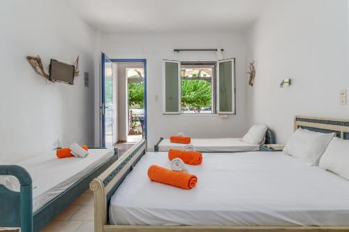 two beds in a room with two windows at Perasma Studios 9 in Kipri