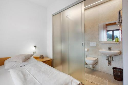 a bathroom with a bed and a sink and a shower at Harmony room in Piano