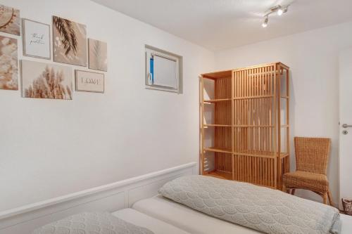 a bedroom with a bed and a book shelf at Bachblick in Buchenbach