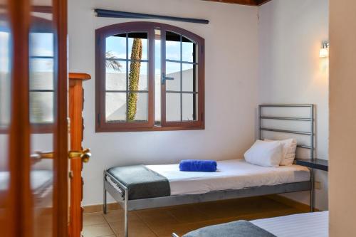 a small room with a bed and a window at Villa Gauda in Lanzarote
