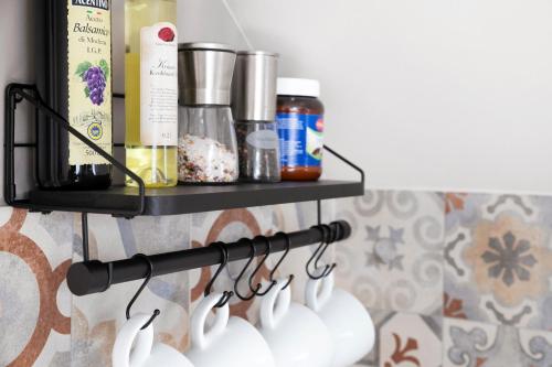 a rack of coffee cups on a wall at Uhses Ferienwohnung in Heide
