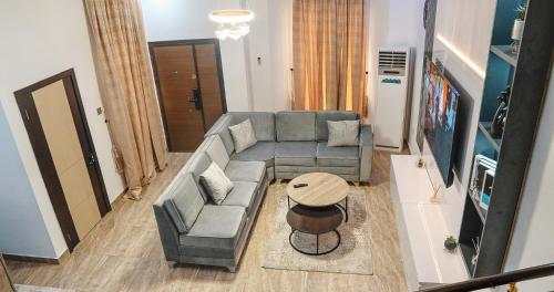 a living room with a couch and a table at Urban Haven - Orchid, Lekki in Lekki