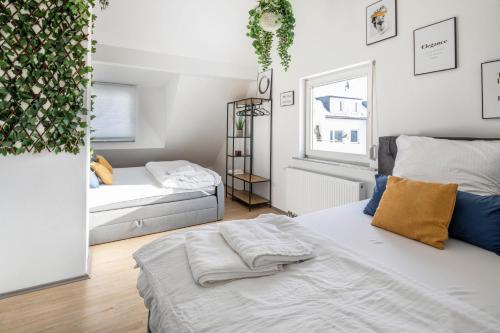 a bedroom with two beds and a window at Hue Space Air in Kassel
