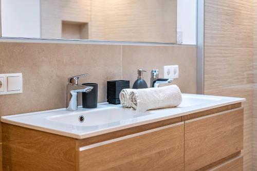a bathroom sink with two faucets on top of it at Penthouse - Apartment Venosta in Naturno
