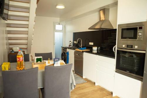 a kitchen with a table and a counter top at Casa do Troféu in Relva