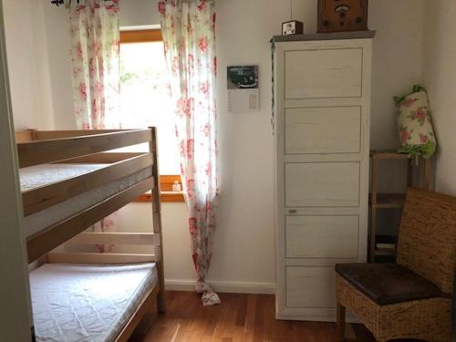a bedroom with a bunk bed and a window at Haus Leenja in Beverungen
