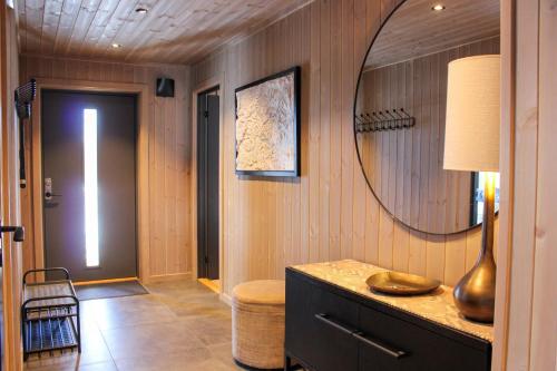 a room with a mirror and a dresser and a hallway at Beitostølens smørblomst in Beitostøl