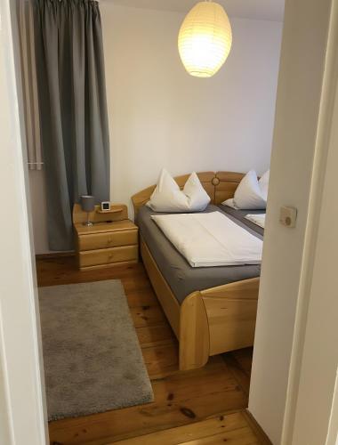a small bedroom with two beds and a lamp at Fewo Forchheim in Forchheim