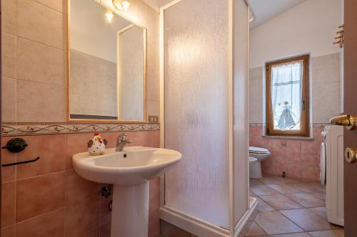 a bathroom with a sink and a mirror and a toilet at Casa Valeria Costa Paradiso in Trinità d'Agultu e Vignola