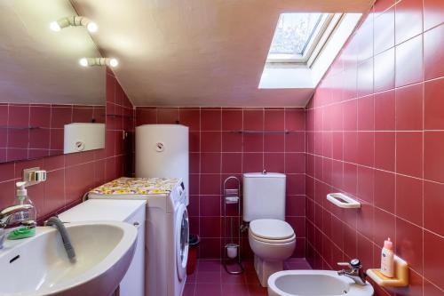 a bathroom with a toilet and a sink at Loft parallela lungomare posto auto in Viareggio