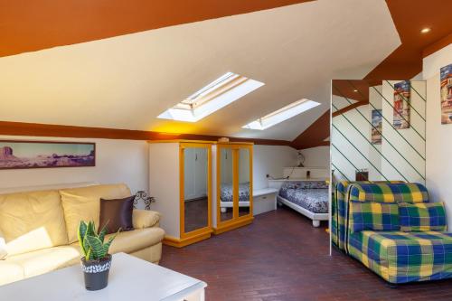 a living room with a couch and a bed at Loft parallela lungomare posto auto in Viareggio