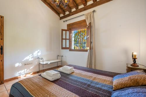 a bedroom with a bed with two towels on it at Casa Rocío Castril in Castril
