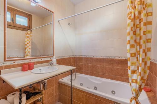 a bathroom with a sink and a tub at Casa Rocío Castril in Castril