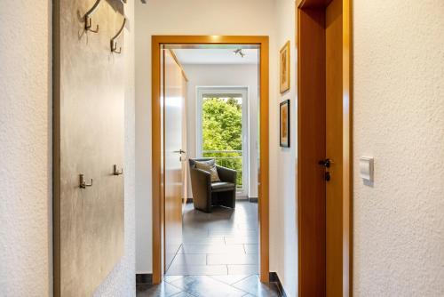 a hallway with a door and a chair in a room at Ferienwohnung Tannenblick 6-1 in Oberhof