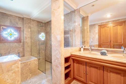 a bathroom with two sinks and a shower at Can Maro in Santa Margalida