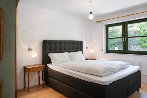 a bedroom with a bed and a window at Panorama Apartment Todtmoos in Todtmoos