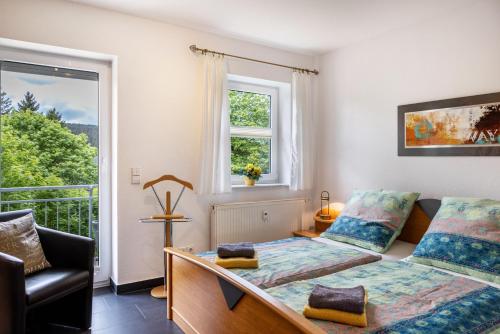 a bedroom with two beds and a balcony at Ferienwohnung Tannenblick 6-1 in Oberhof