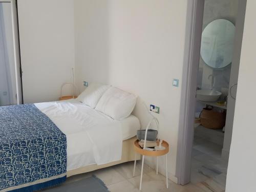 a bedroom with a bed and a sink and a mirror at I have a big dream in Agia Pelagia