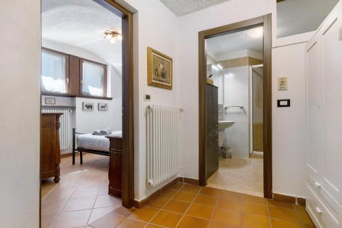 a hallway with a bathroom with a sink and a mirror at Antico Casolare di Alice in Cares
