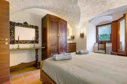 a bedroom with two beds and a mirror on the wall at Antico Casolare di Alice in Cares