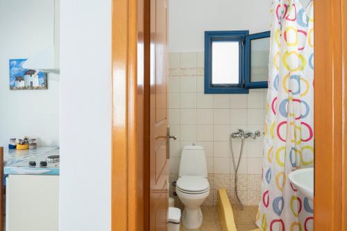 a bathroom with a toilet and a sink at Studios Ninemia Serifos 3 in Livadi