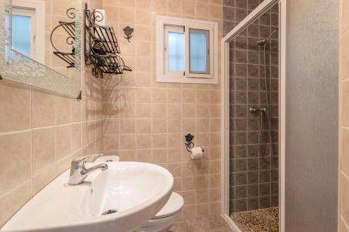 a bathroom with a sink and a toilet and a shower at Cortijo Encarni in Frigiliana