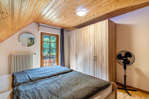 a bedroom with a bed and a large window at Ferienhaus Gießler in Nordrach