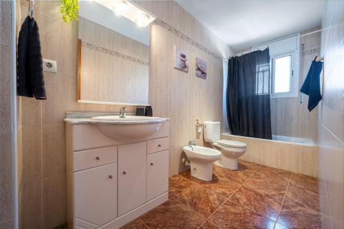 a bathroom with a sink and a toilet at another day in paradise in Calafell