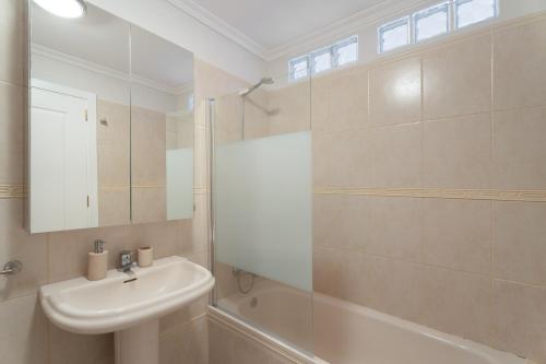 a white bathroom with a sink and a shower at Ático Bellavista B - Alcalá in Guía de Isora