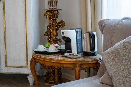 a table with a coffee maker and a coffeemaker on it at Hotel Genova Liberty in Genoa
