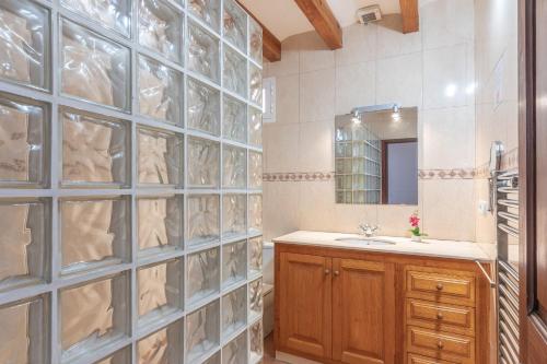 a bathroom with a sink and a glass wall at Cas Pobres in Sóller