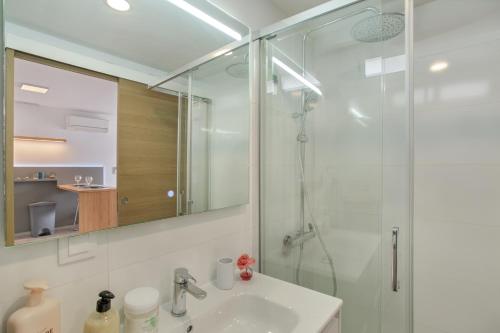 a bathroom with a sink and a glass shower at Sun and serenity pool wifi in Puerto Rico de Gran Canaria