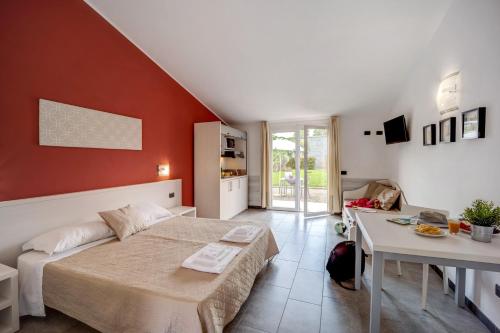 a bedroom with a bed and a table in it at Appartamento Monolocale Rebi in Imperia