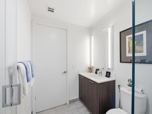 a bathroom with a toilet and a sink at Brickell Bay View in Miami