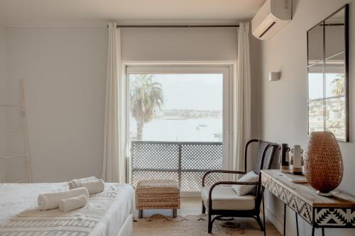a bedroom with a bed and a large window at Cascais Bay Terrace I in Cascais
