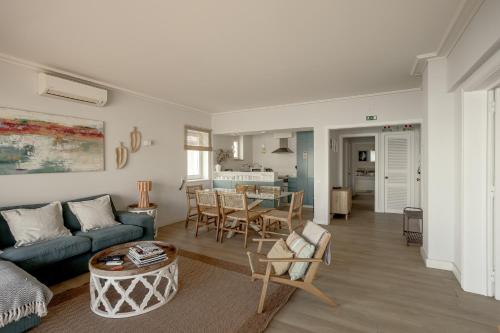 a living room with a couch and a table at Cascais Bay Terrace I in Cascais