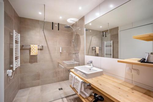 a bathroom with a sink and a mirror at Stoana Apt 2-2 in San Giacomo