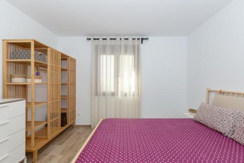 a bedroom with a bed and a book shelf at Casa La Puente in Mijas