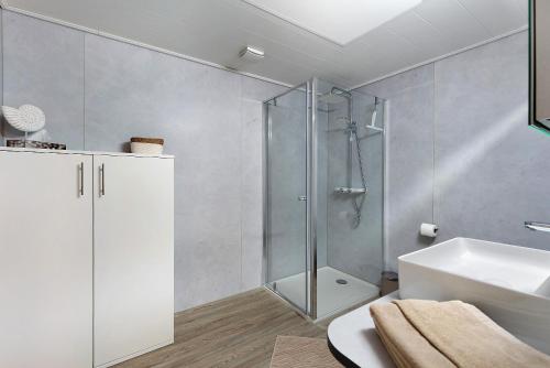 a bathroom with a shower and a sink at Haus Birkenösch in Aach-Linz