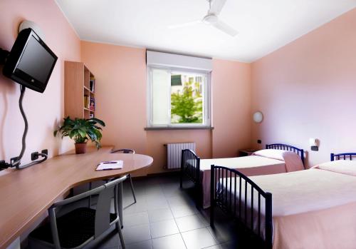 a room with two beds and a desk and a tv at La Cordata Accommodation - Zumbini 6 in Milan